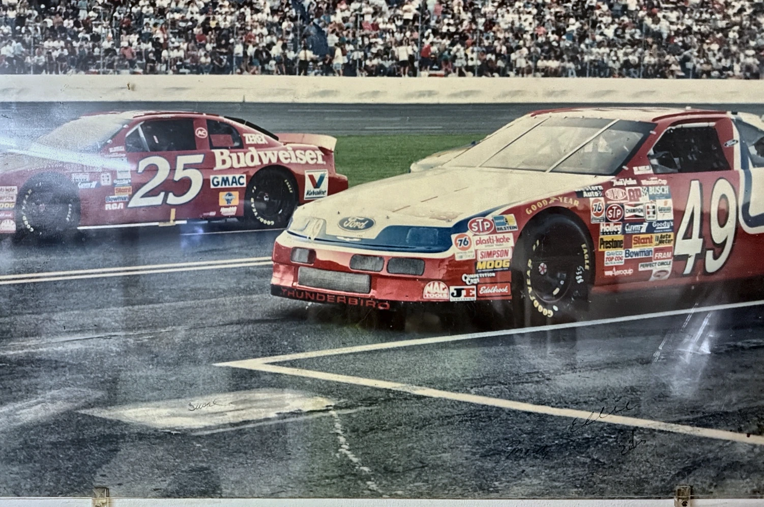 Historical photograph of the number 49 and number 25 race cars on the track