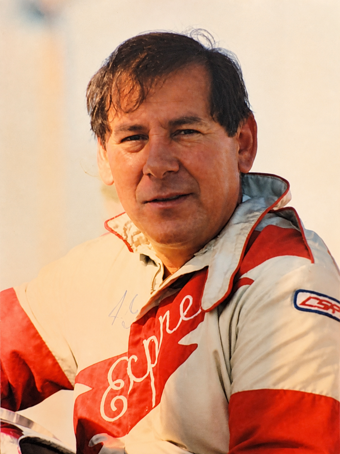 Historical portrait of a 49 Express race driver in a red and white racing suit