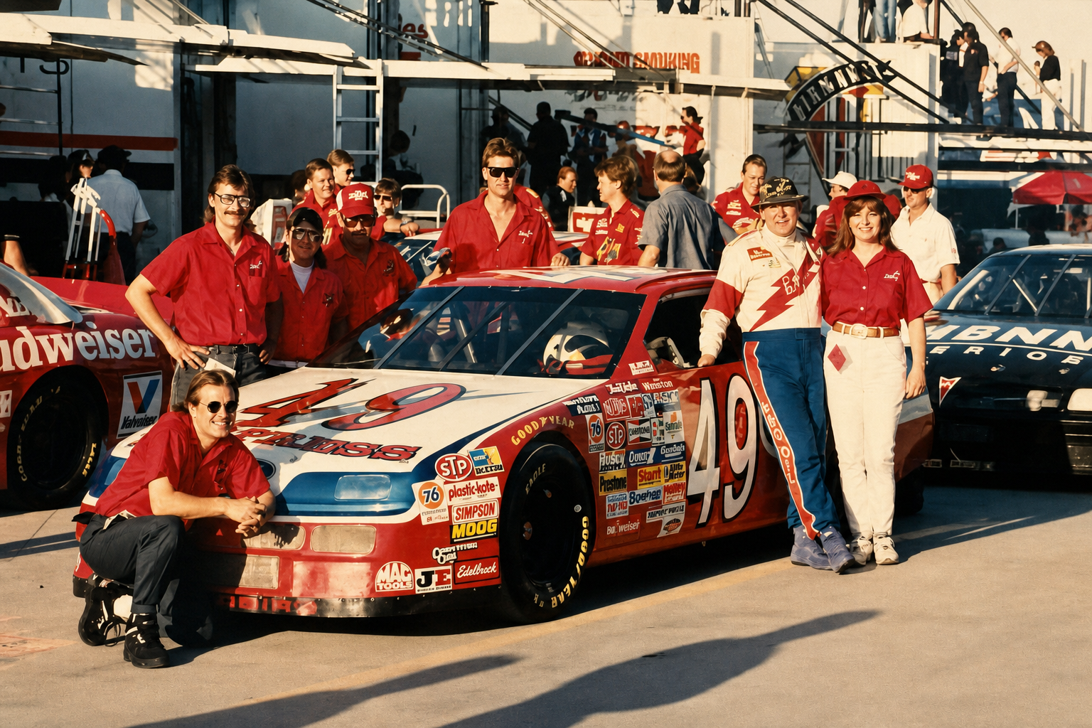 Historical photograph of the number 49 race team gathered around the race car