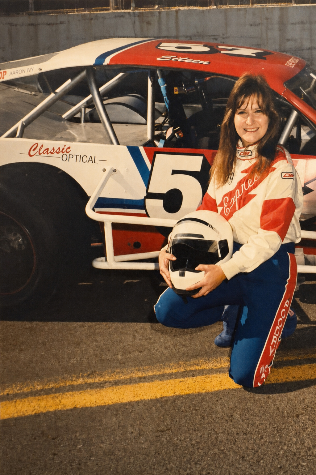 Number 57 driver photographed with the race car and helmet